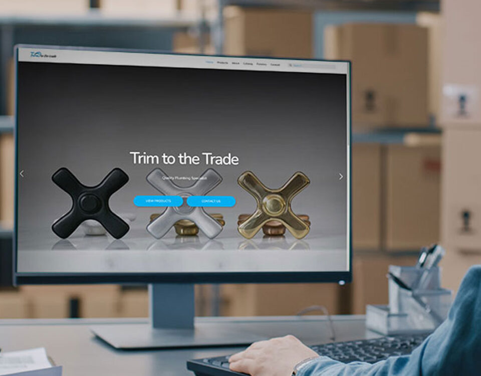 Man sitting at a computer looking at the Trim to the Trade website