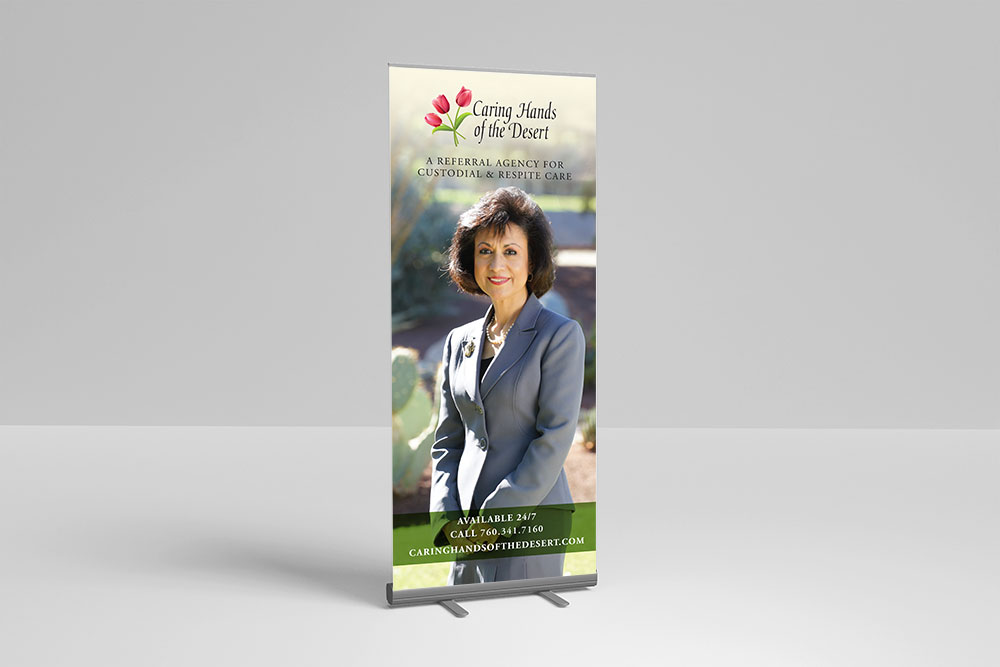 Photo of retractable banner showing Caring Hands brand artwork