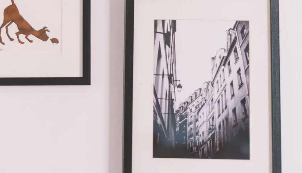 Office pictures framed on a wall of a building and a dog sniffing the ground illustration